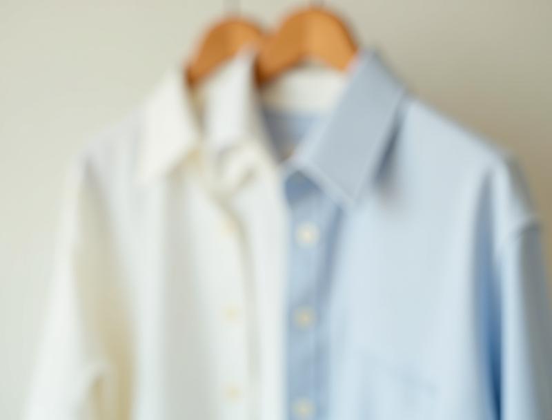 Stylish casual shirt draped gracefully over a wooden hanger, highlighting relaxed elegance.